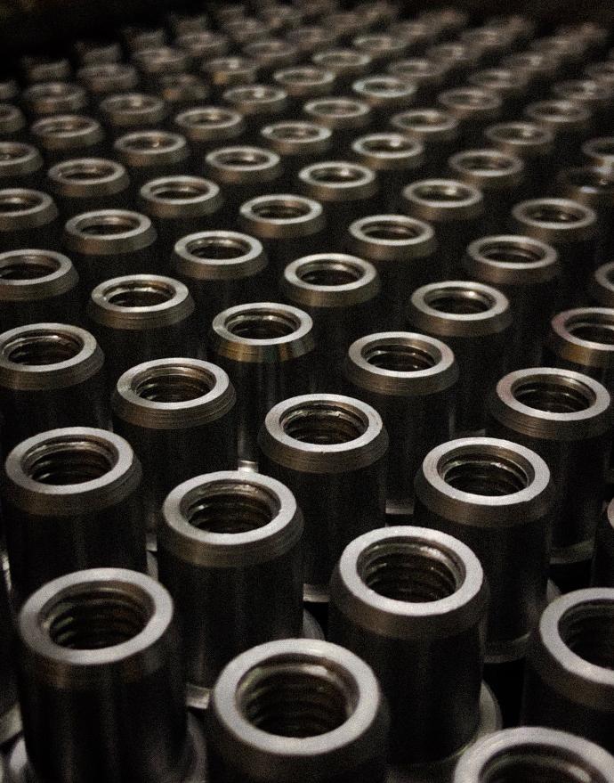 a large group of metal flanges sitting on top of a table